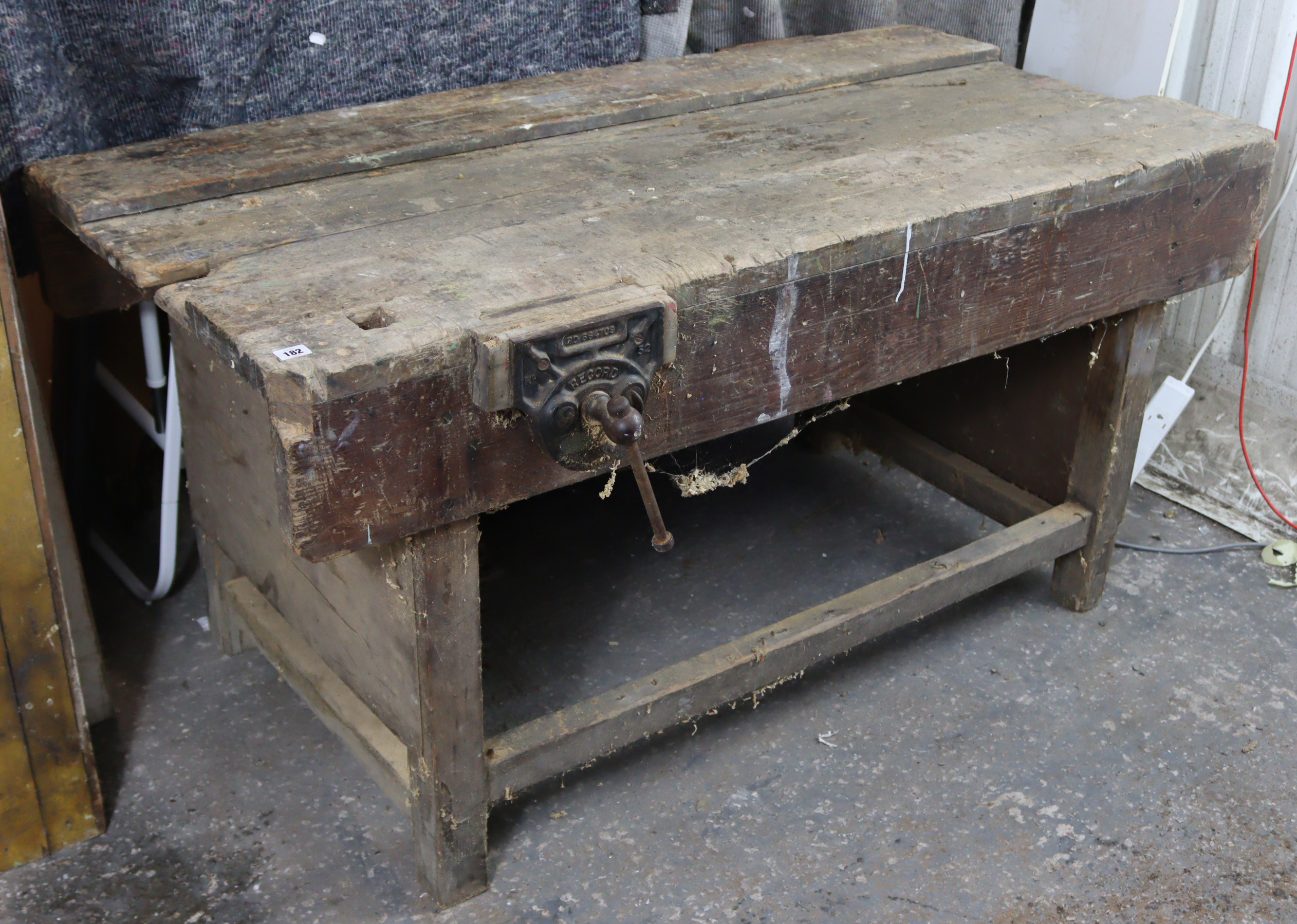 A wooden carpenter’s work bench on square legs with plain stretchers, & fitted with a Record No.