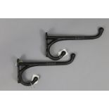 Two reproduction cast-iron “G. W. R.” coat hooks, 11½” long.