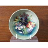 A Moorcroft pottery floral decorated small bowl, 4¼” diam. x 1¾” high.
