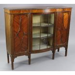 An early-mid 20th century mahogany break-front side cabinet, fitted six shelves enclosed by glazed