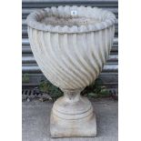 A reconstituted-stone garden urn of spiral-fluted design, & on square pedestal foot, 18” diam x