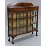 An Edwardian mahogany bow-front china display cabinet with gadrooned edge, fitted two shelves