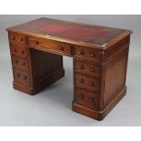 A Victorian-style mahogany pedestal desk, inset gilt-tooled crimson leather to the rectangular