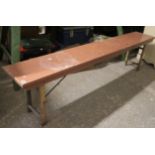 A pine bench with rectangular top & on square fold-away legs, 72” long x 17¾” high.
