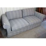 A bed-settee with scroll ends & with loose cushions to seat, upholstered pale blue & ivory chequered