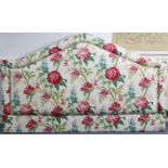 A large padded headboard, upholstered multi-coloured floral material, 79” long x 47½” high.