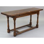 A reproduction oak refectory table with rectangular fold-over top, & on four baluster-turned legs