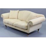 A modern three-seater settee with shaped back, scroll-arms & with loose cushions to the seat