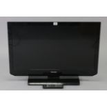 A TOSHIBA 32” television with remote control, lacking power lead. Model No. 32EL833B.