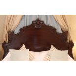 A 19th century-style hardwood double headboard with moulded scroll & bird design to the shaped back,