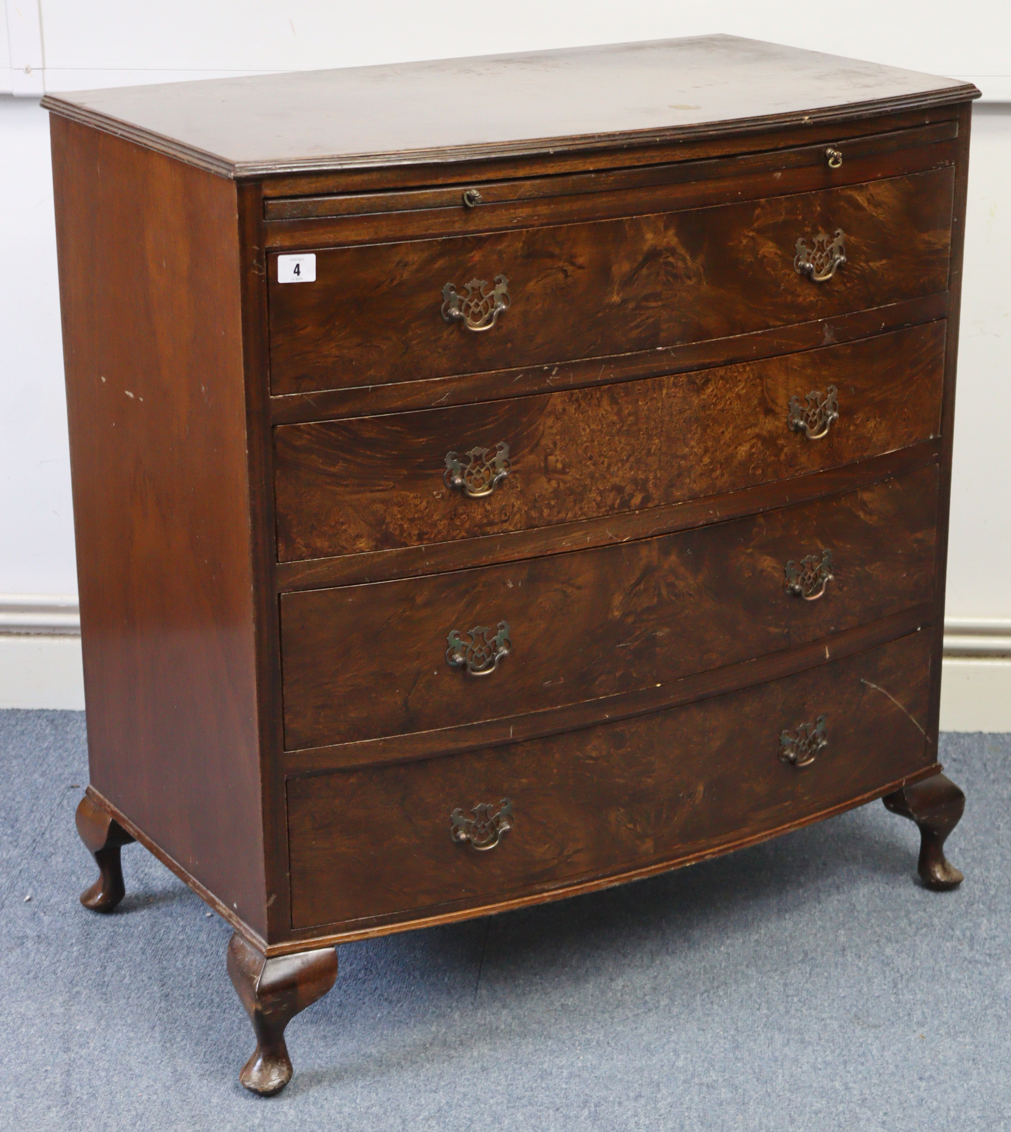 A reproduction walnut small bow-front chest, fitted brushing slide above four long graduated drawers