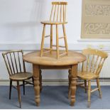A pine dining table with moulded edge to the circular top, &on four baluster-turned legs, 41½”