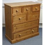 A pine chest, fitted with an arrangement of five short & two long drawers (lacking three knob