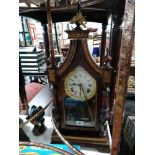 A mantel clock in carved pine case, 24” high; another in pottery case; a 400-day mantel clock; a