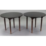 A pair of mahogany-finish bar-room tables, each with circular top, & on four fluted tapering legs,