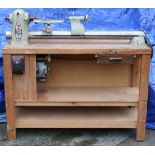 A Myford carpenter’s lathe fitted with a 230V motor, & mounted on a wooden bench, w.o., 48” long.