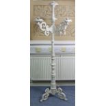 A Victorian-style white painted aluminium standard lamp with three scroll-arms, & on triform base,