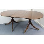 A regency-style mahogany twin-pedestal dining table, with D-shaped ends, two additional leaves, & on