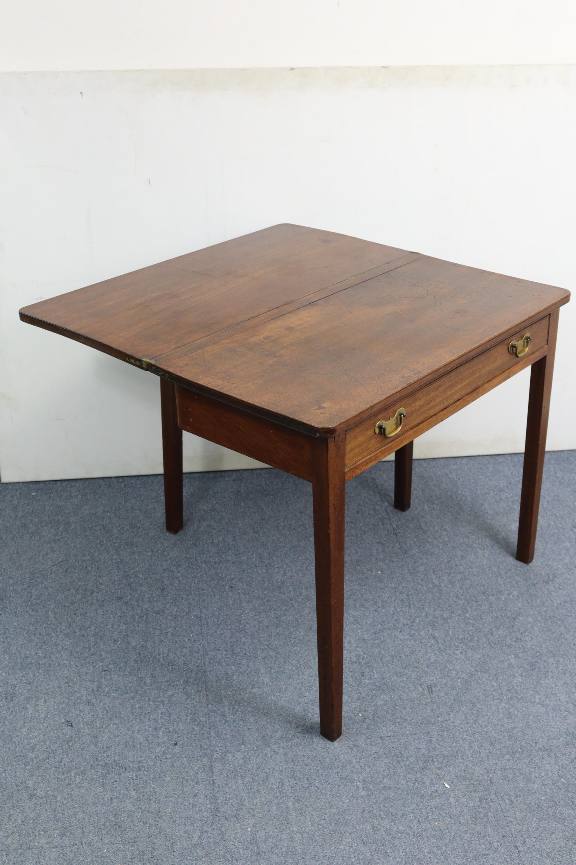 A 19th century mahogany tea table with rectangular fold-over top, fitted frieze drawer & on square - Image 5 of 7