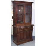 A late Victorian mahogany tall standing bookcase, with moulded cornice above three adjustable