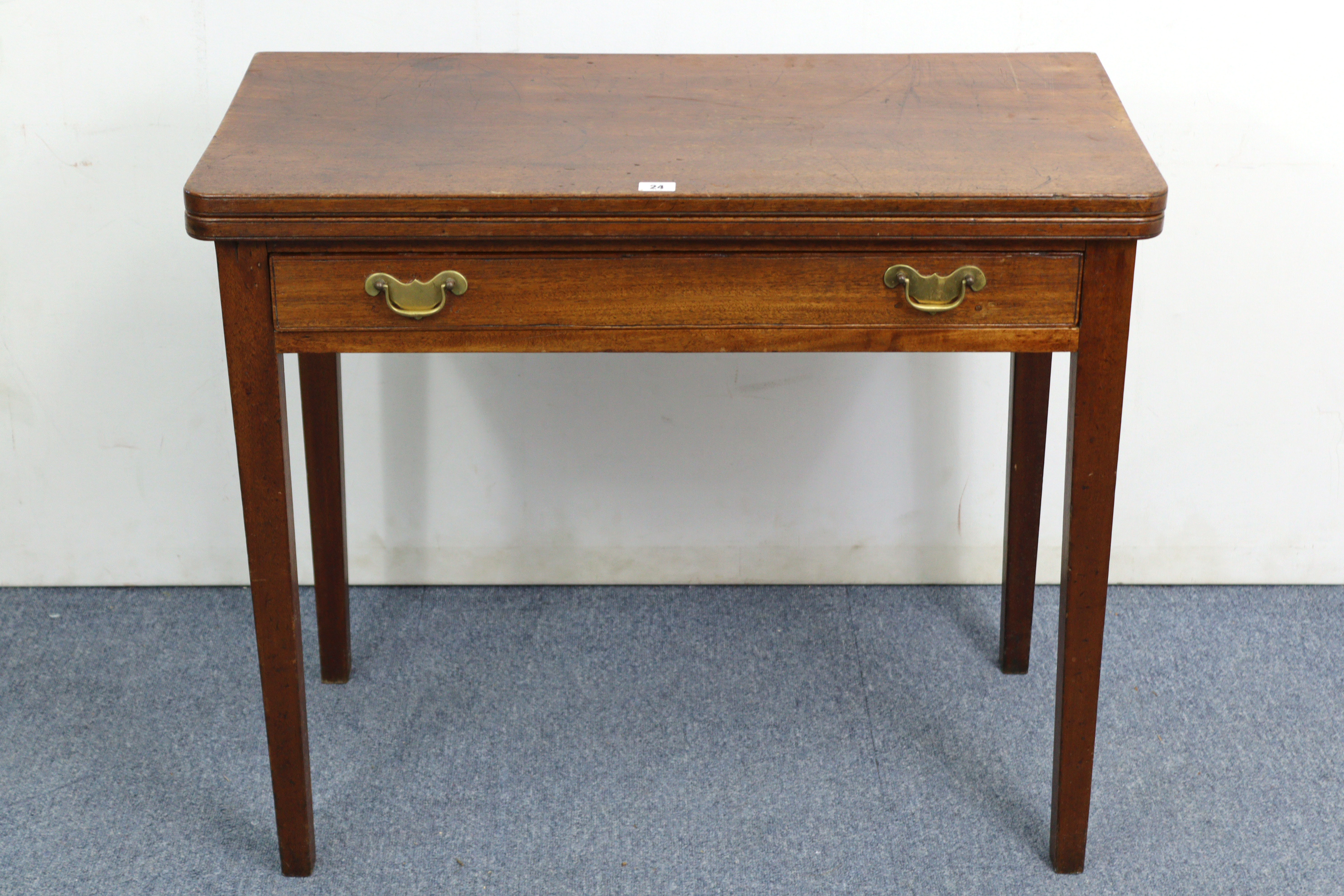 A 19th century mahogany tea table with rectangular fold-over top, fitted frieze drawer & on square - Image 2 of 7