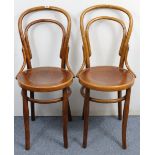 A pair of bentwood café chairs with circular hard seats, & on round tapered legs.