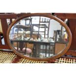 An oval wall mirror inset bevelled plate, & in walnut frame, 24½” x 34½”; together with various