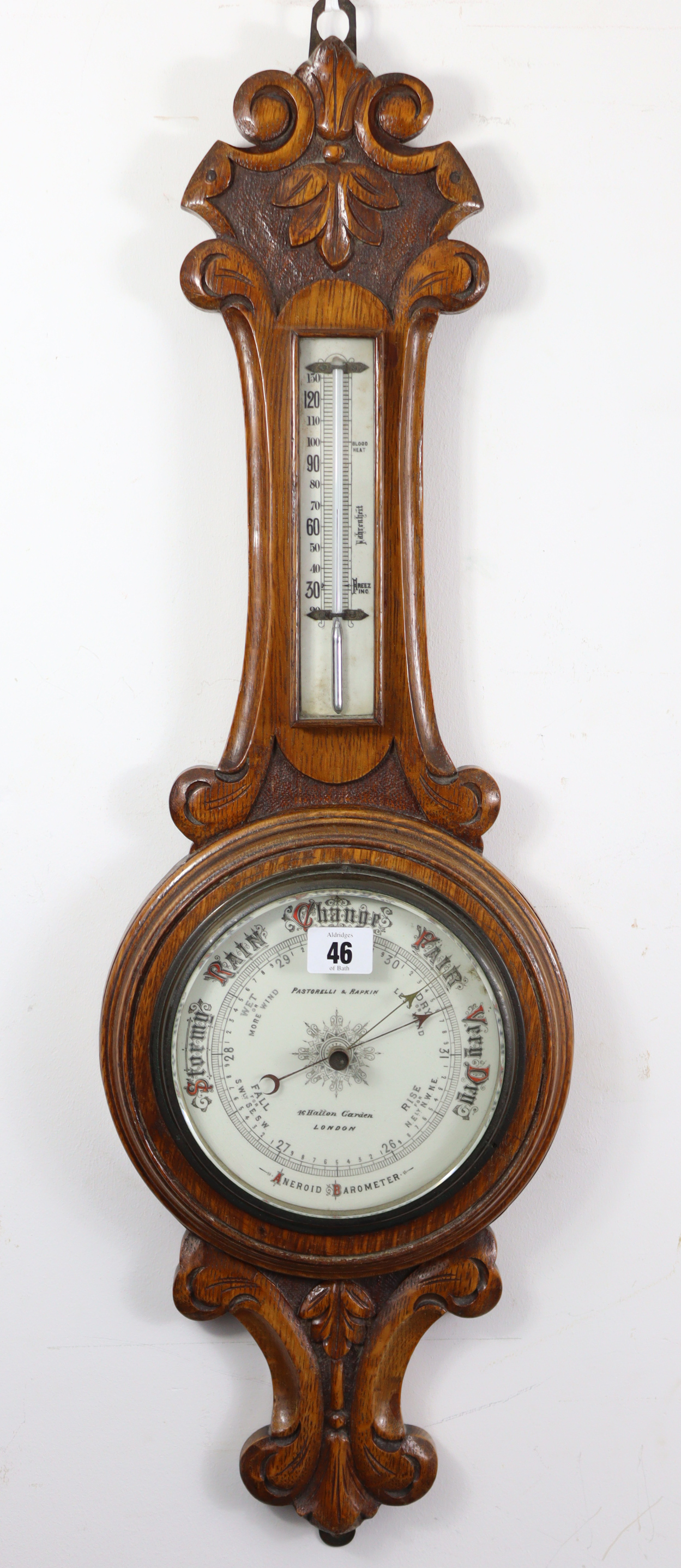 A late 19th/early 20th century aneroid wall barometer, the white enamel dial signed “Pastorelli &