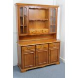 A Younger's cherrywood tall side unit, the upper part fitted open shelf to centre above three small