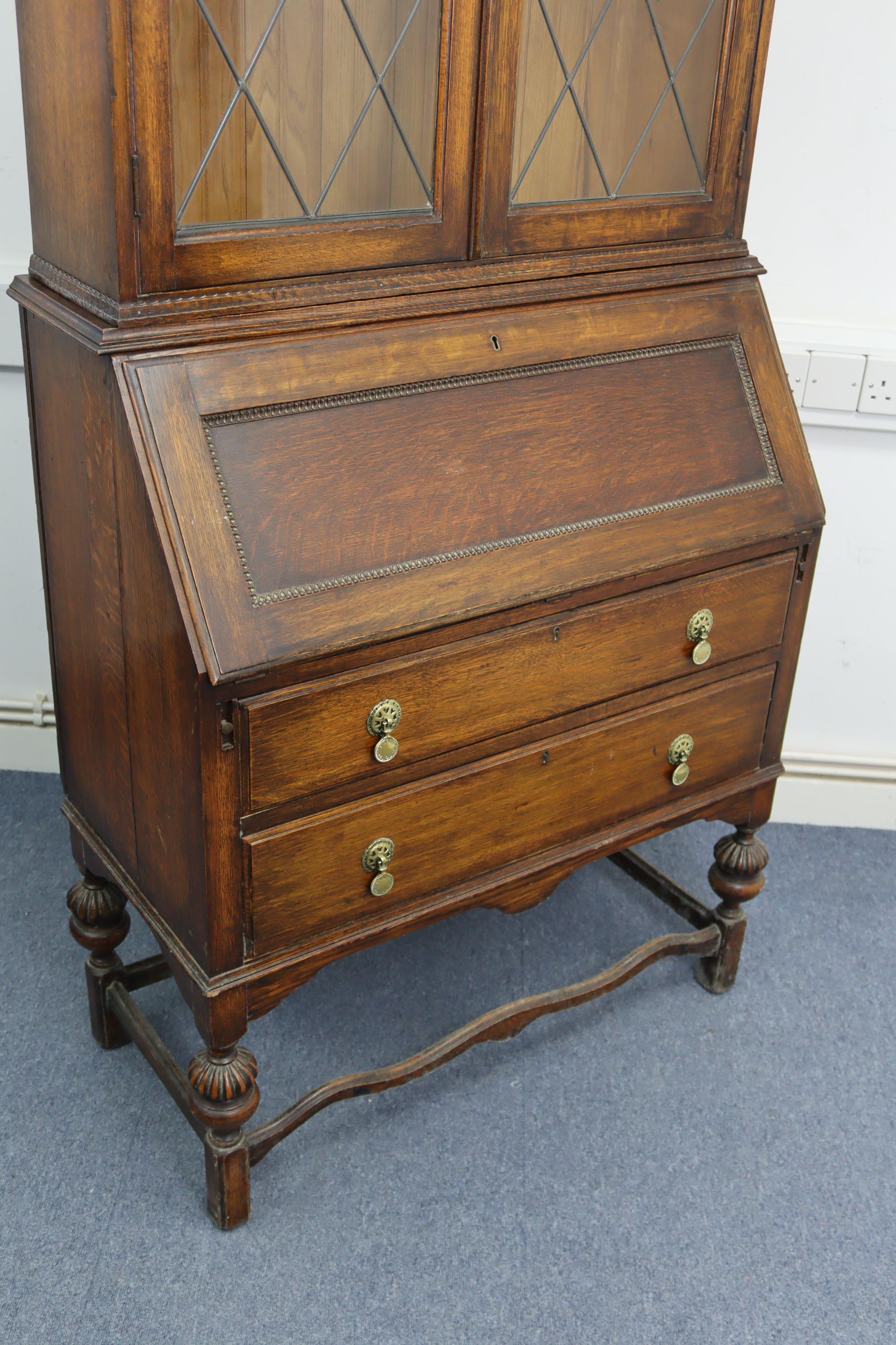 A 1930’s oak bureau-bookcase, the upper part with two adjustable shelves enclosed by pair of - Image 2 of 4