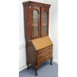 A mahogany matched bureau-bookcase, the upper part with three adjustable shelves enclosed by pair of