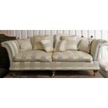 A Knole-style three-seater drop-end settee with shaped back & scroll-arms upholstered gold & cream