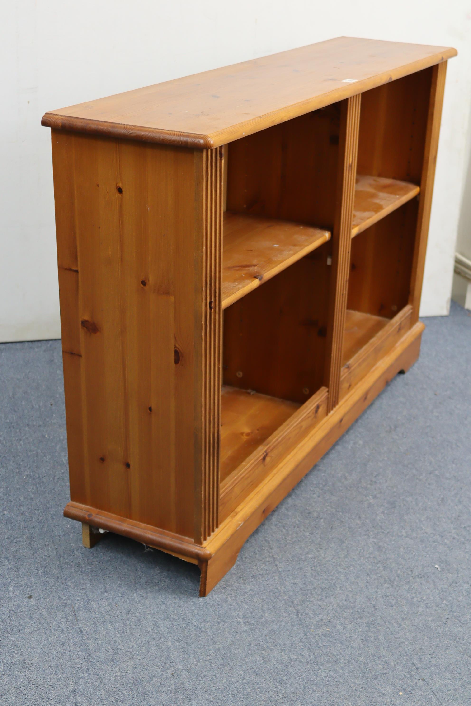 A pine low standing open bookcase with two adjustable shelves, & on shaped plinth base, 47” wide x - Image 2 of 3