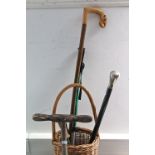 A reproduction ebonised walking cane with plated knob handle; three wooden trinket boxes; a carved