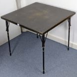 A regency-style ebonised wooden card table inset black baize, & on four ring-turned fold-away