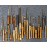 Twenty-seven various carpenter’s wood turning gouges.