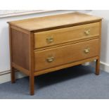 An oak low chest, fitted two long graduate drawers with brass swing handles, & on short square legs,