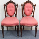 A pair of Victorian carved beech occasional chairs with buttoned backs & sprung seats upholstered