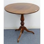 A late George III mahogany tripod table with circular top, & on vase-turned centre column & three