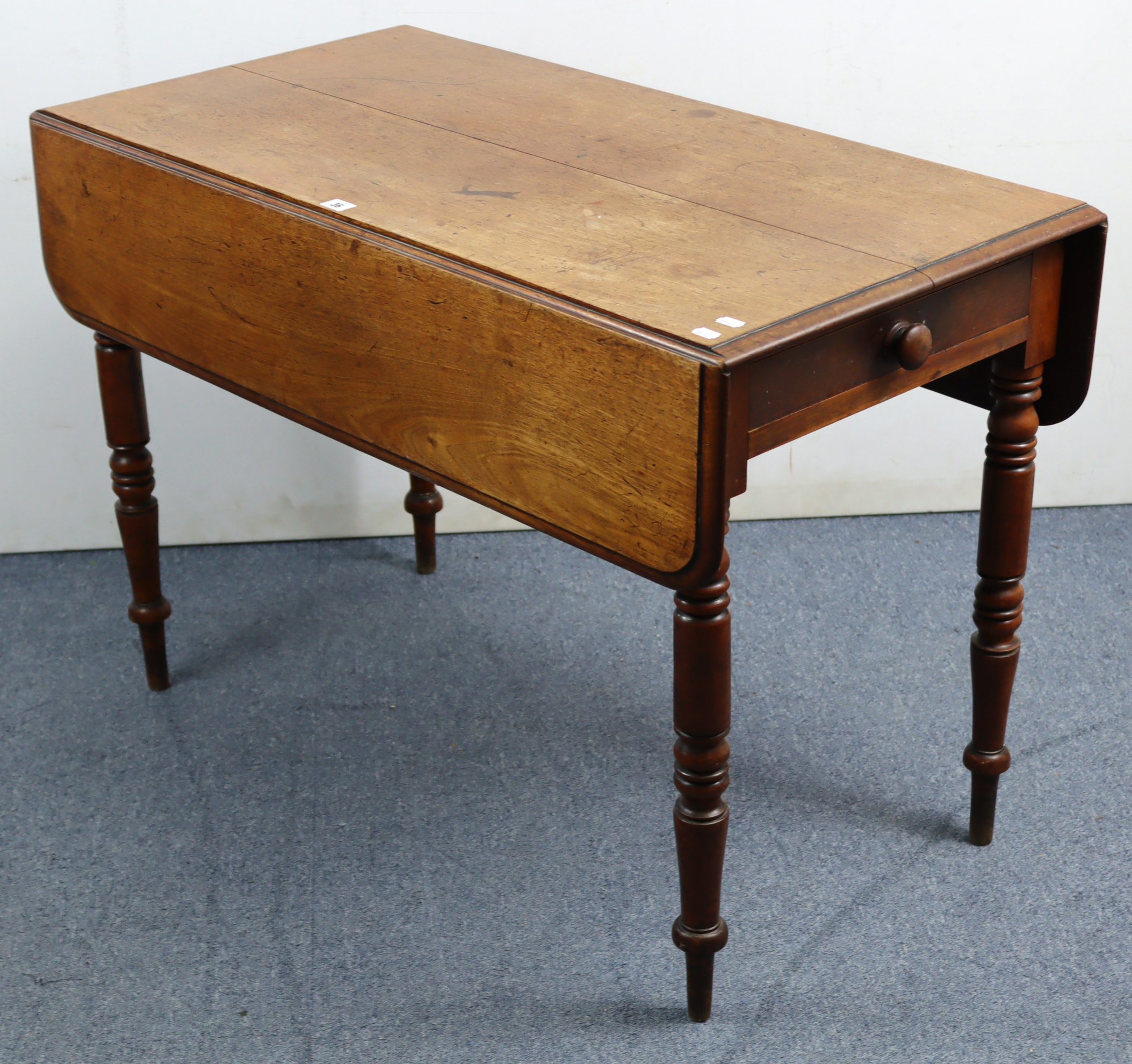 A 19th century mahogany Pembroke table, fitted end drawer & on ring-turned tapered legs, 41” wide.