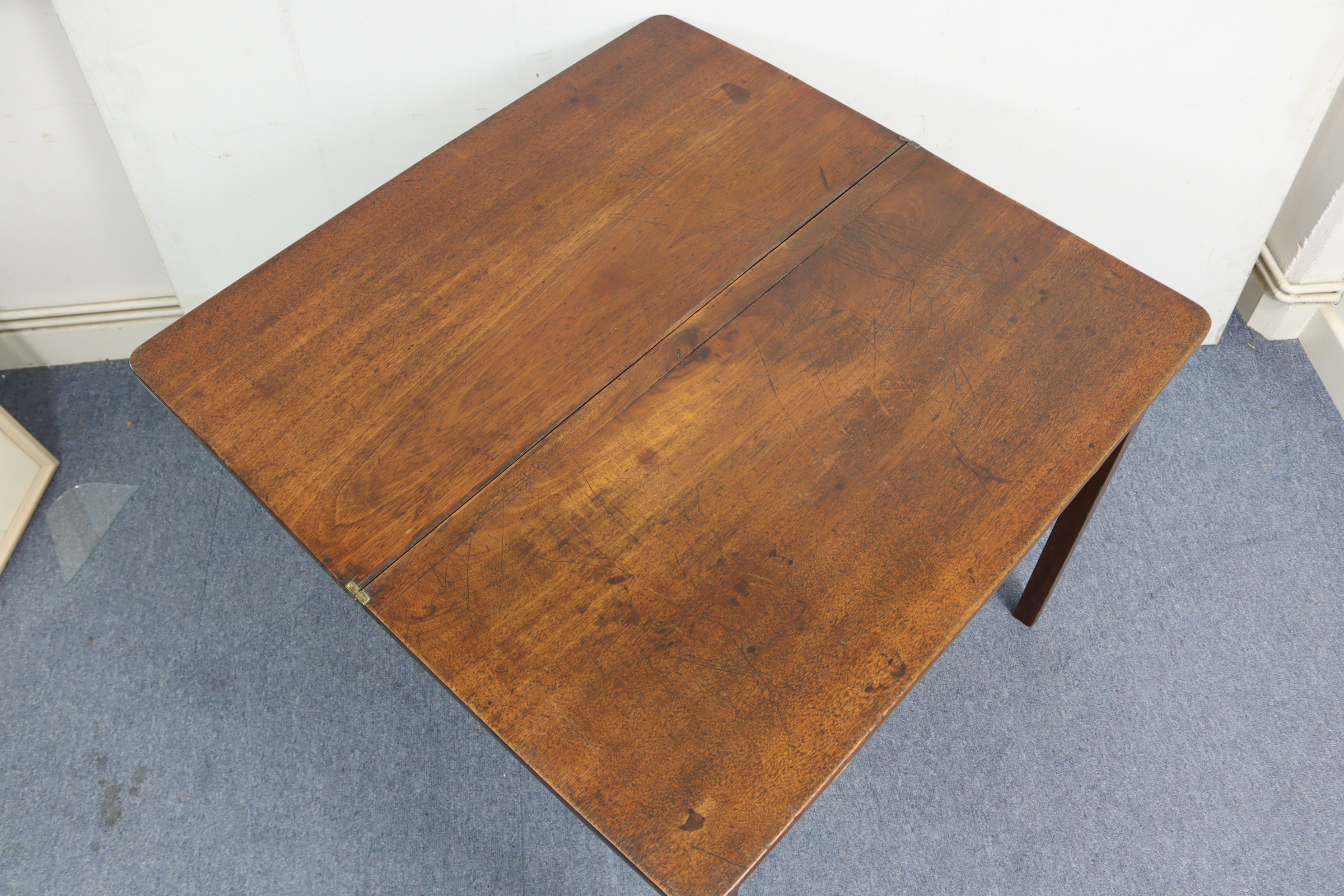 A 19th century mahogany tea table with rectangular fold-over top, fitted frieze drawer & on square - Image 6 of 7