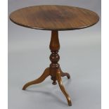 A George III style mahogany circular tripod table on baluster turned centre column & slender