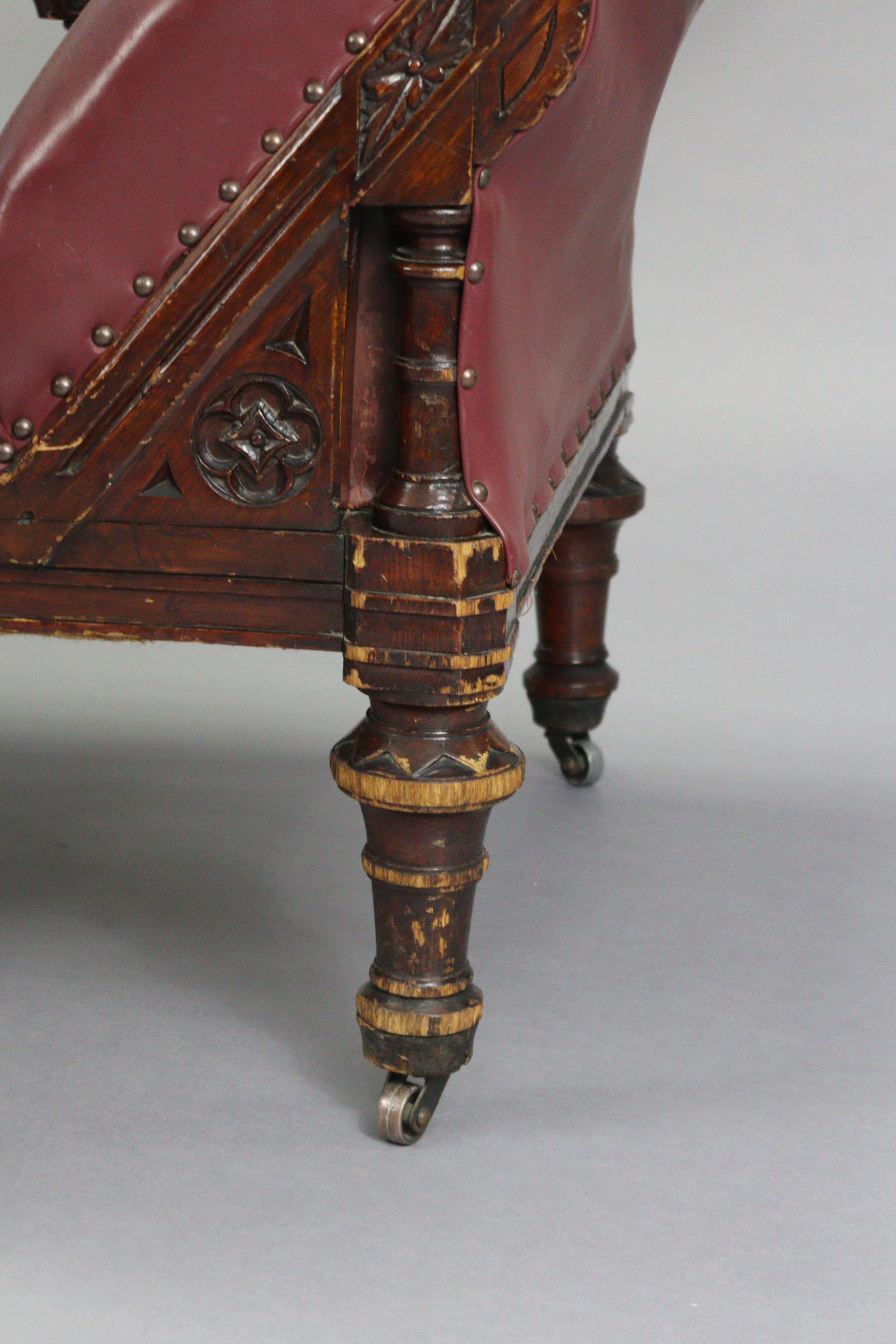 A Victorian carved oak frame chaise longue upholstered brass-studded crimson leather, with foliate - Image 4 of 6