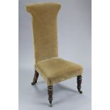 A Victorian prie-dieu chair upholstered old gold velour, on turned rosewood legs with brass