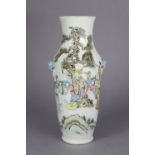 A Chinese porcelain slender baluster vase decorated in famille verte enamels with figures on a