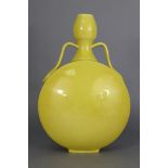 A 19th century Chinese porcelain monochrome yellow moon flask of typical form, with garlic neck &