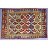 A Choli kelim rug of ivory ground, with all-over repeating geometric design in red, orange, green, &