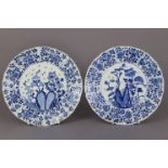 A pair of Chinese blue & white porcelain plates with lotus-petal rims decorated with foliage, the
