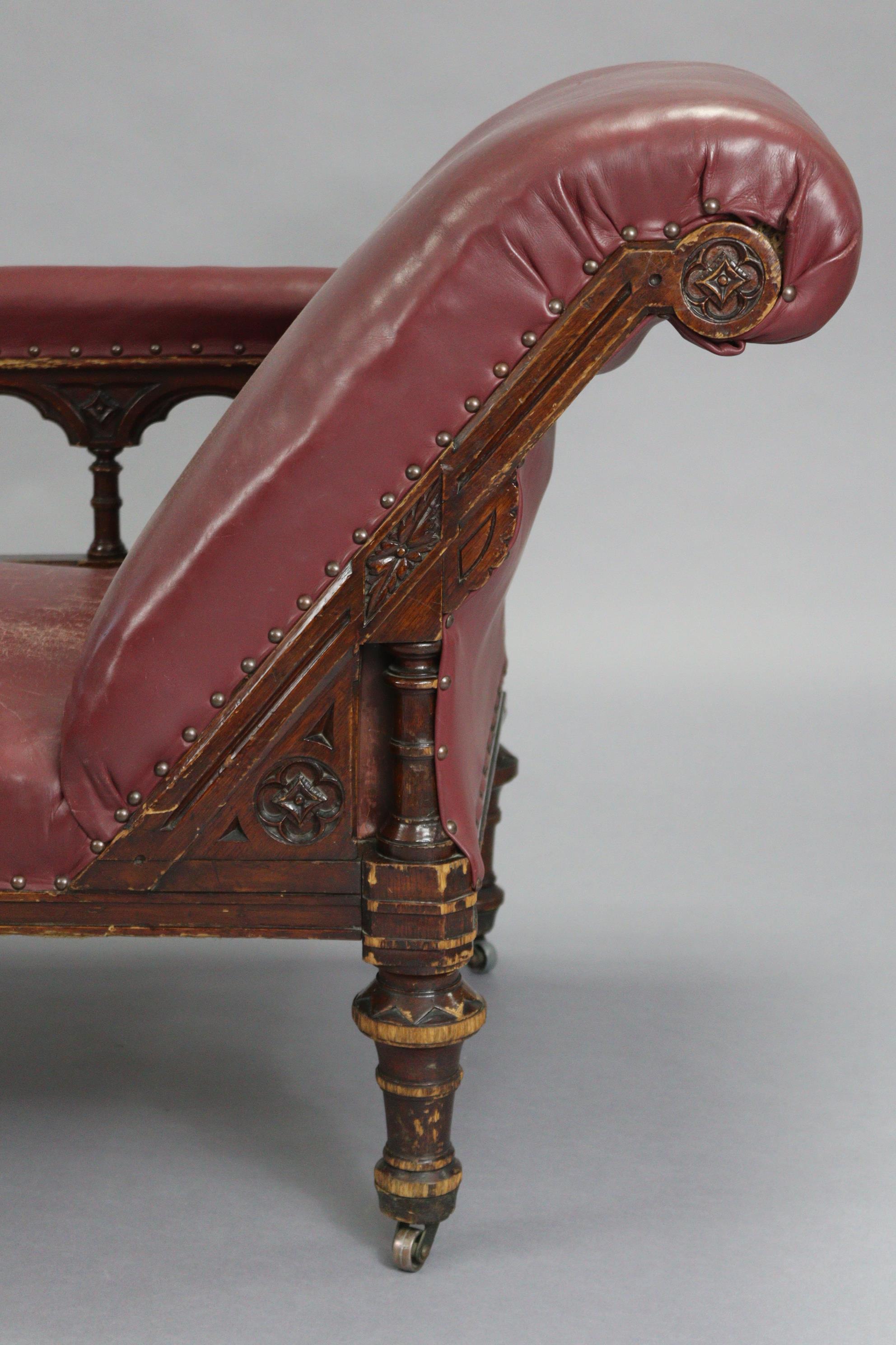 A Victorian carved oak frame chaise longue upholstered brass-studded crimson leather, with foliate - Image 2 of 6
