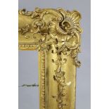 A 19th century giltwood & gesso large picture frame with foliate decoration & shell-&-scroll corners